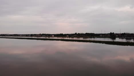 Calm-Reflective-Tranquil-Sunset-Over-River-Beside-Crezeepolder-Nature-Reserve