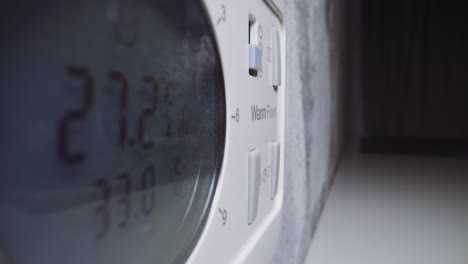 woman starts timer on control panel of microwave oven macro