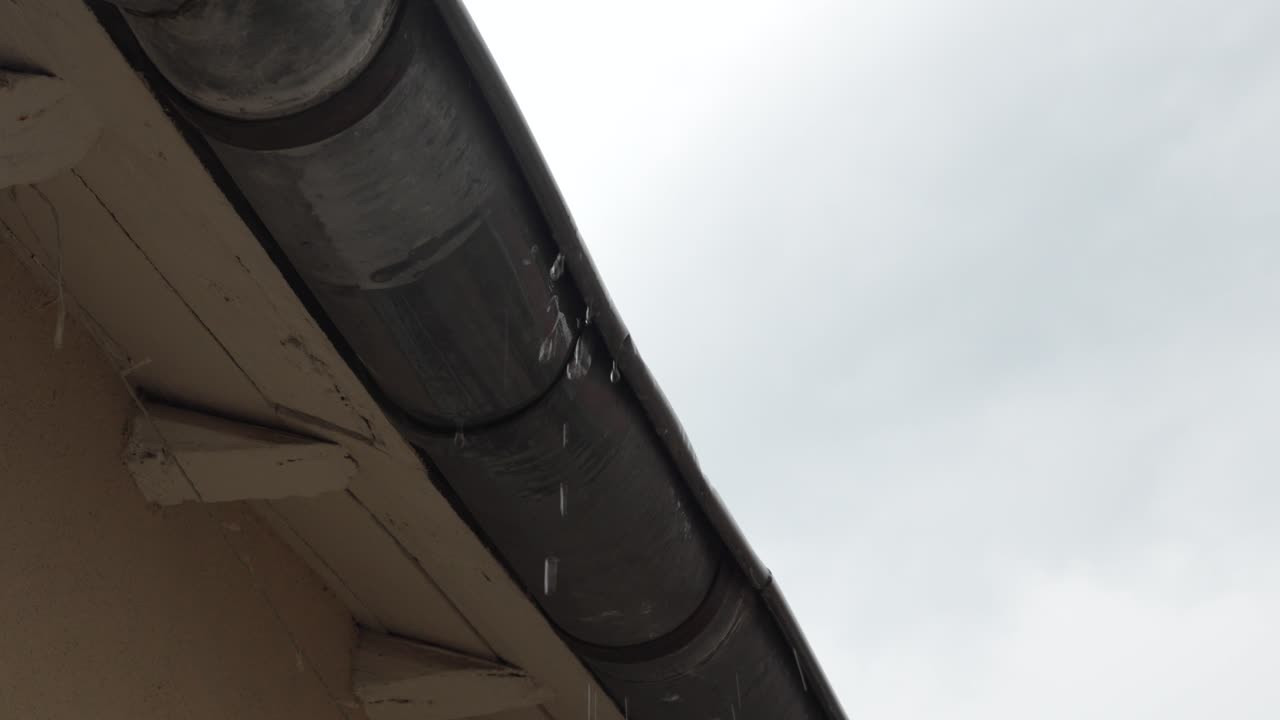 Rain dripping from a rain gutter