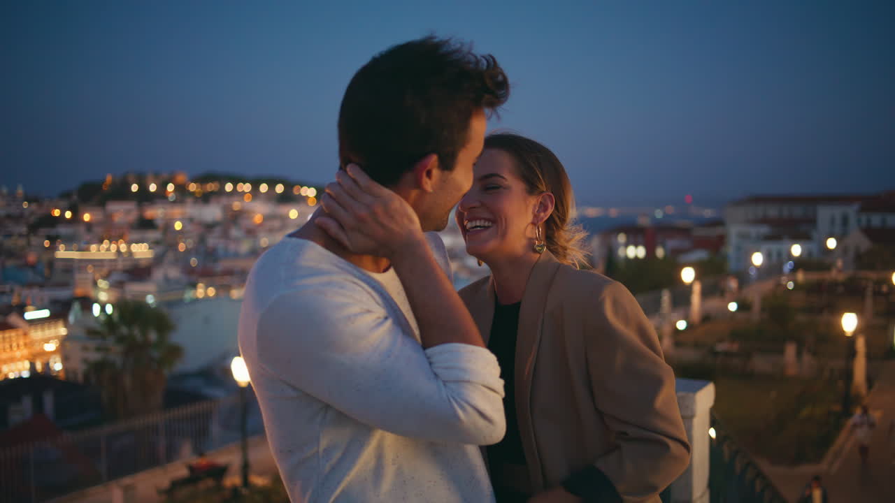 Night couple laughing date at city lights. Closeup happy girl cuddling flirting