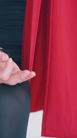 man holds fingers in meditating mudra position sitting in special fly yoga hammock extreme close view