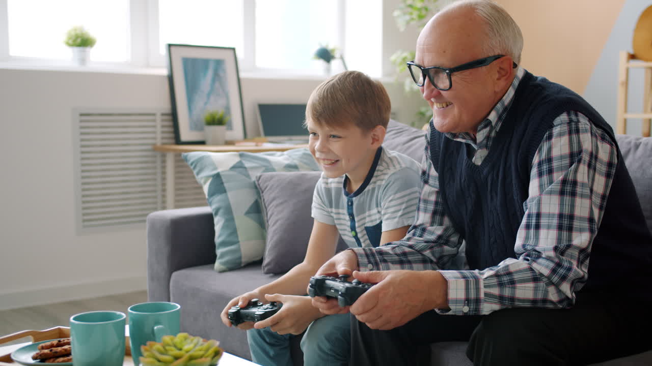 Grandfather and Grandson Playing Video Games Together