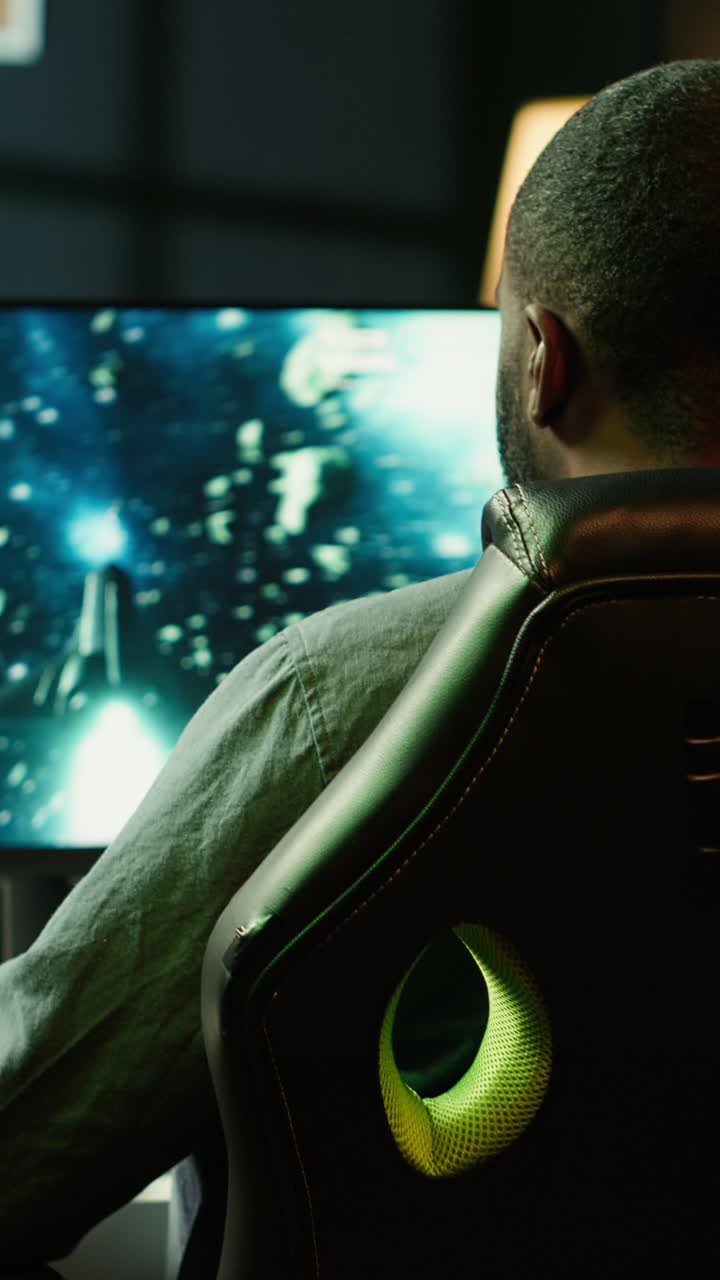 Vertical video Man coming home to play SF space videogame on PC