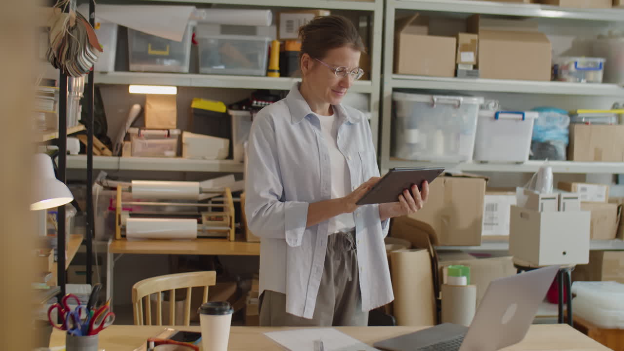 Woman Using Digital Tablet in Delivery Service Warehouse