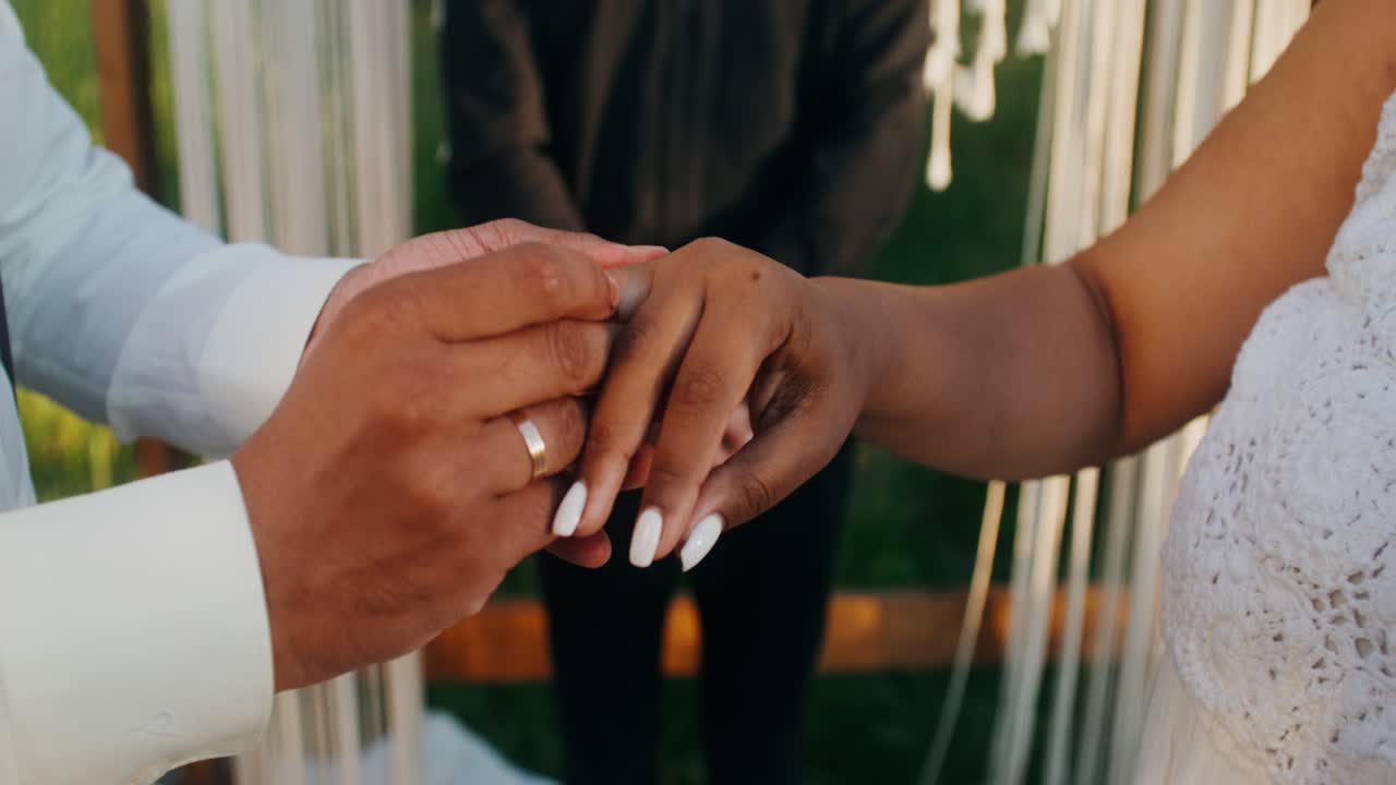 Couple exchanging rings during a wedding ceremony