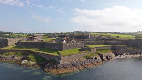star-shaped charles fort by the sea in summer cove, kinsale harbour, county cork, ireland. - aerial pullback shot
