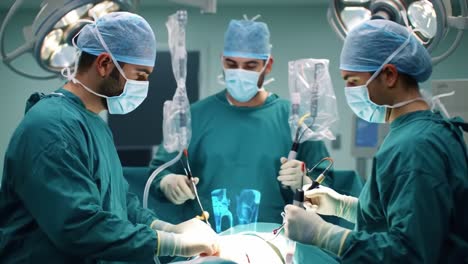multiple surgeons collaborating in an operating room, dressed in surgical attire, wearing face masks and caps, engaged in a procedure with medical instruments