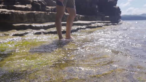 young man with his feet in the water in the sea.