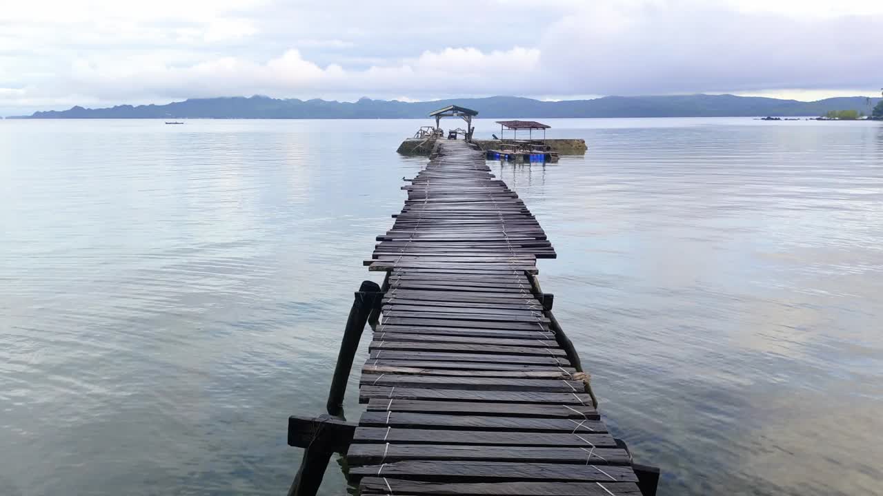 Travelling in Asia, Calm dawn morning over wooden boat dock and ocean