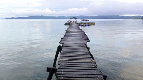 travelling in asia, calm dawn morning over wooden boat dock and ocean