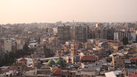 aerial view of old arabic town with green domes of mosque during sunset in tripoli, northern lebanon