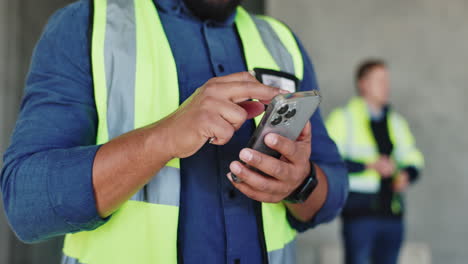 construction worker using smartphone on site