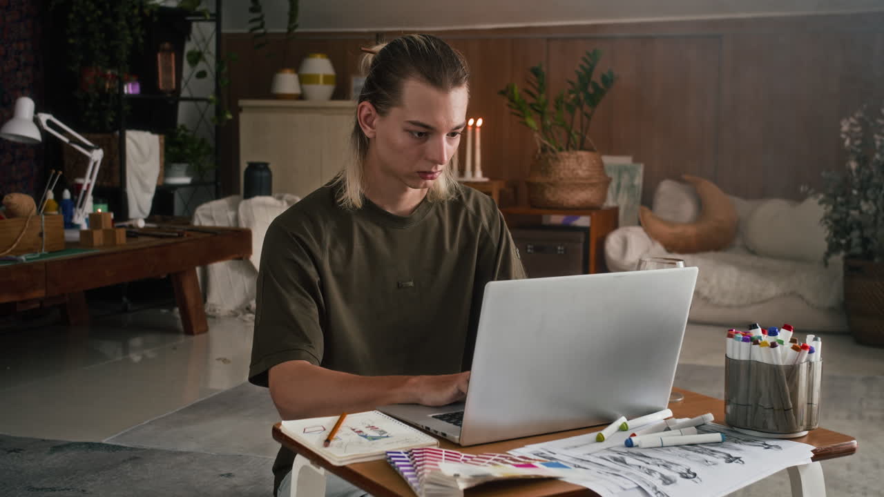 Male Designer Working on Laptop at Workshop