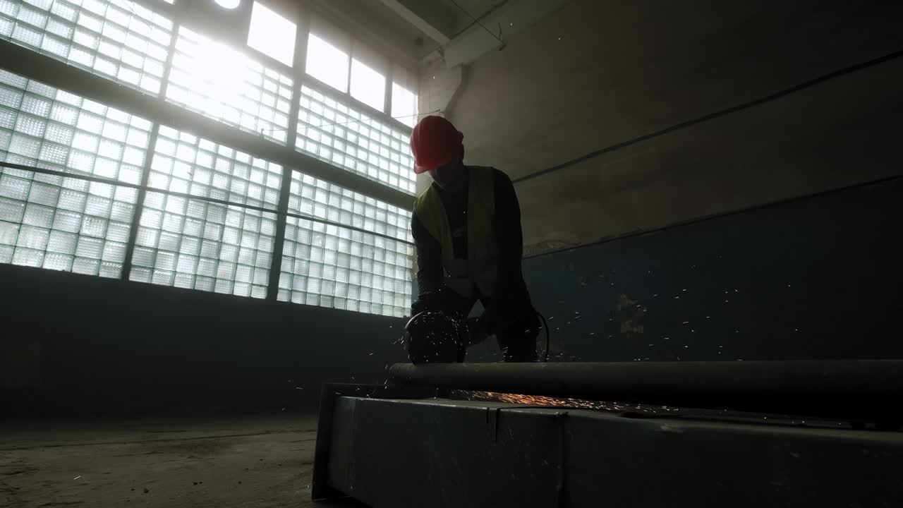 Construction worker cuts steel with a circular saw, construction worker's feet, flying sparks from a circular saw. Move camera motion
