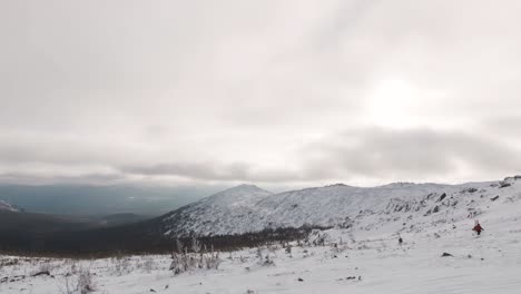 snowy mountain range under cloudy sky