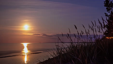 timelapse of majestic sunrise over the sea with waves crashing on the beach