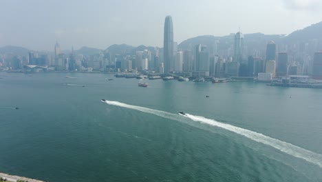 hong kong coastguard boats roaring across the open bay waters, aerial view