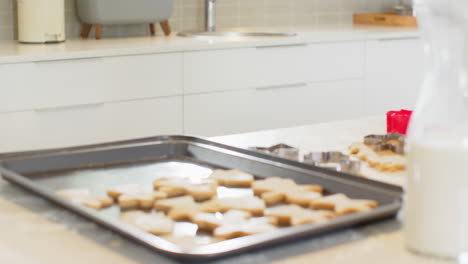 christmas time, baking holiday cookies in kitchen with milk and cookie cutters