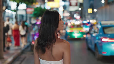 woman walking in a night city street