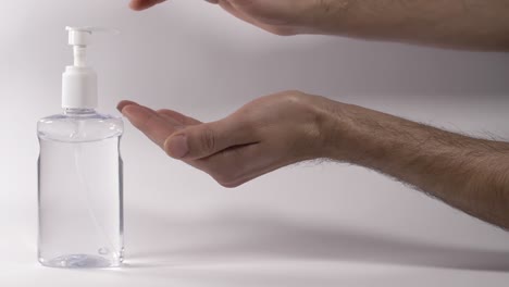 Personal-hygiene-using-alcoholic-based-hand-sanitizer-against-white-background