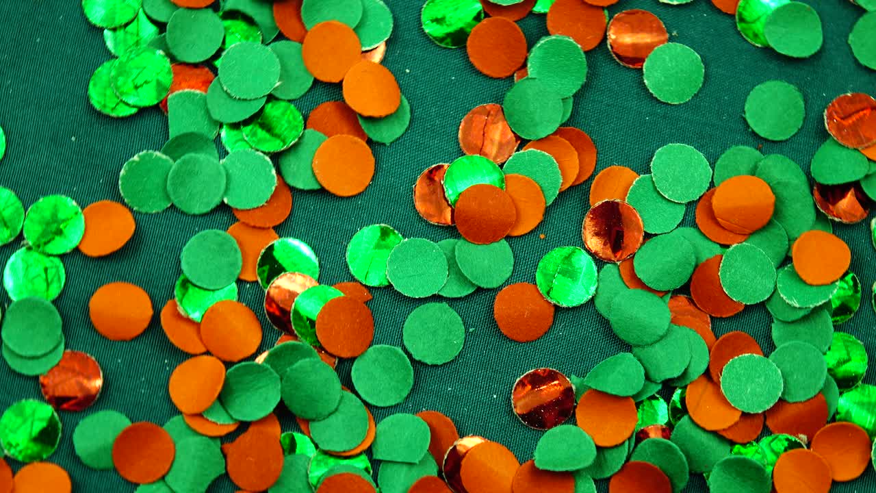 Scattering of green and red confetti, festive background