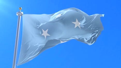 bandera de micronesia agitando en el viento con el cielo azul en lento, bucle
