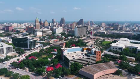 landscape drone shot of the city of san antonio downtown that includes the famous hemisfair park, tower of life building and the city's skyline from the south side of town