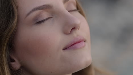 close up portrait of beautiful woman enjoying calm seaside at sunset exploring spirituality looking up praying contemplating journey relaxing on beach