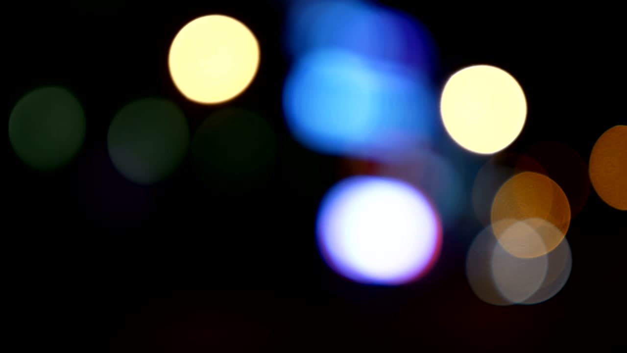 Defocused lights Los Angeles street abstract . City blur background. Moving bokeh circles of night traffic.