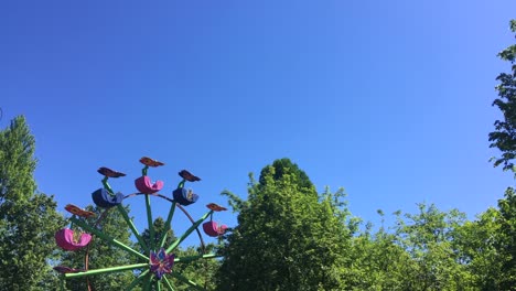children's colorful ferris wheel in an amusement park on a summer sunny day
