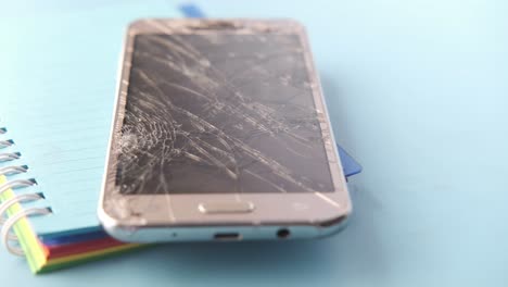 broken smartphone on notebook