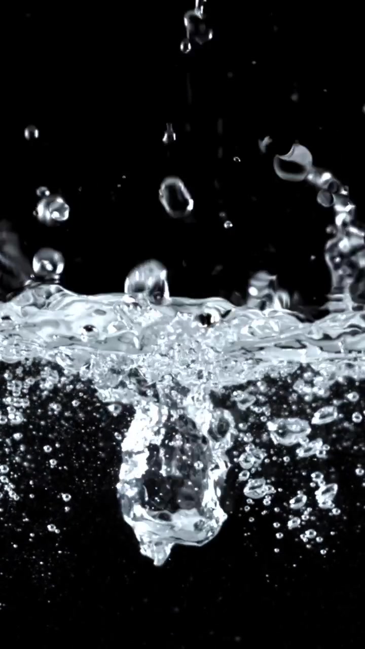Clear Water Splashes and Bubbles in Slow Motion on Black