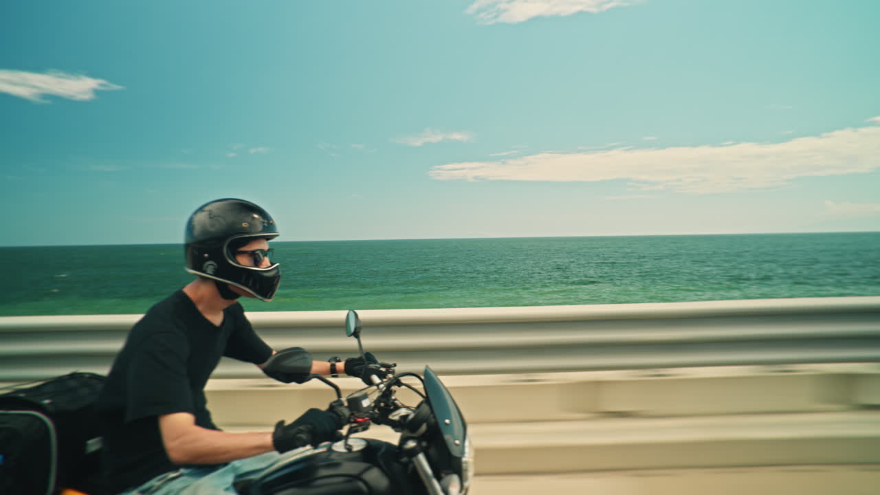 Man riding motorcycle along the coast