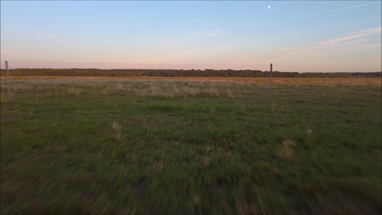 drone volando hacia atrás en la gran llanura húngara, entre cables