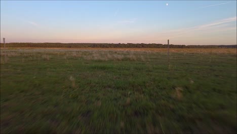 Drone-flying-backwards-on-the-hungarian-big-plain,-between-wires