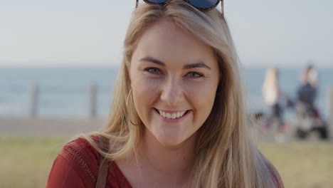 portrait happy young blonde woman laughing enjoying vacation successful female on sunny ocean seaside wind blowing hair slow motion