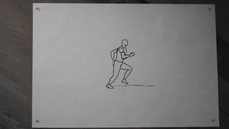 minimalist black and white animation sketch depicting an athlete running, drawn on a sheet of paper attached to a wooden background, suggesting movement and athleticism