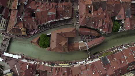 overhead view of le palais de ille and red roof buildings around the thiou river in annecy, france