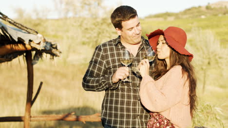 couple tasting white wine in warm sunlight