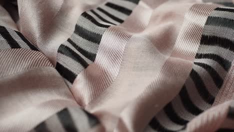 close-up of pink and black striped silk scarf