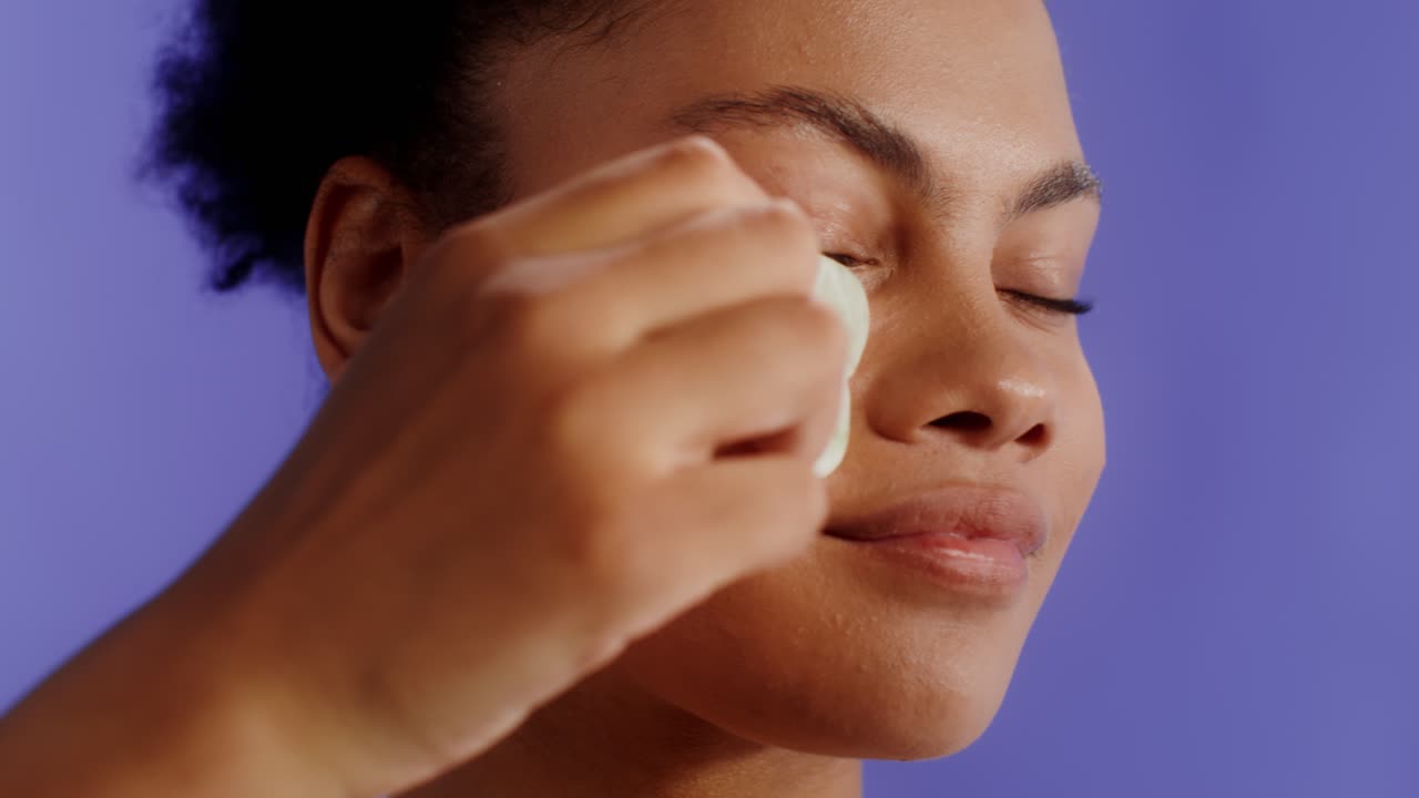 Woman using Gua Sha for facial massage
