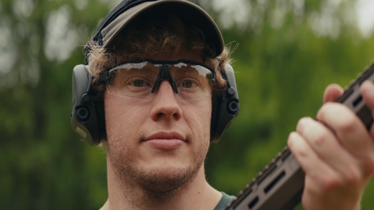 Man with Rifle Wearing Safety Gear