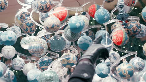 Colorful-Christmas-Balls-swinging-in-the-air-on-the-Christmas-Market-in-Vienna-in-slow-motion