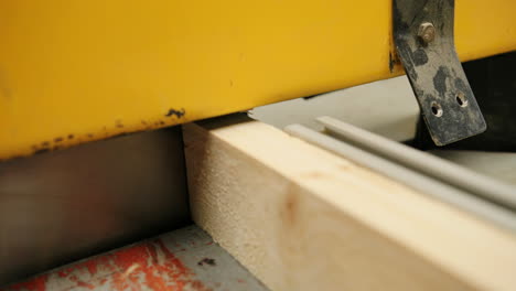 close-up view of wood cutting by a big machine in the wood factory