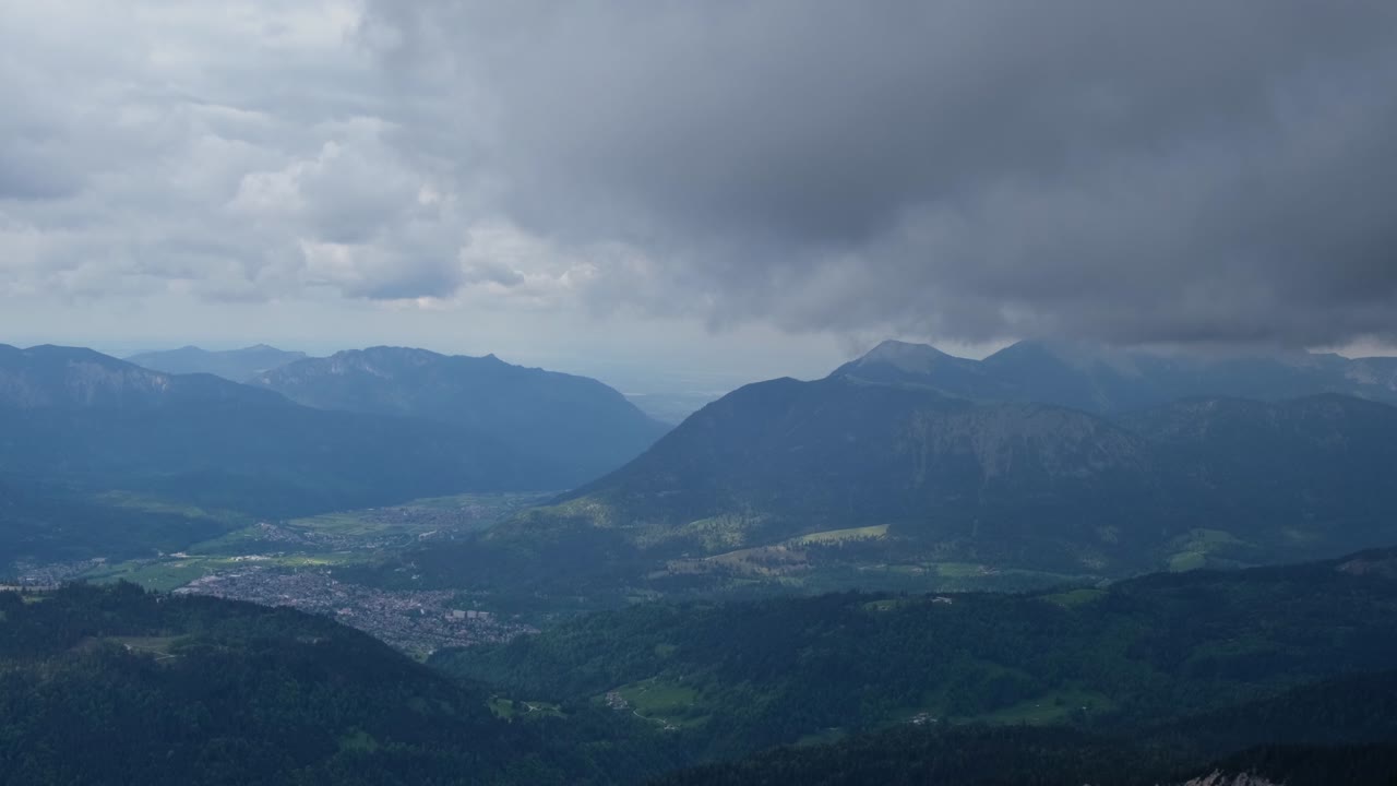 Timelapse of dark clouds rolling over mountains and valleys of a german alpine scenery.