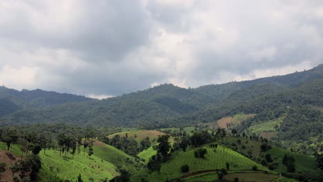 Time-lapse-of-clouds-and-shadow-passing-over-green-valley-and-mountains-before-thunderstorm-coming