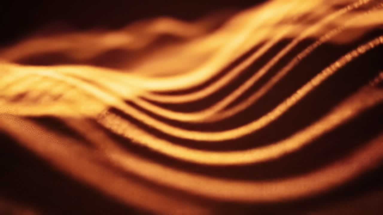 Discover the enchanting movement of golden light waves in a dark atmosphere. This captivating display showcases intricate patterns that shift and flow, captivating the viewer’s attention.