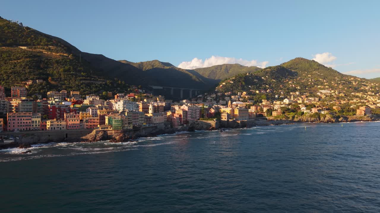 Sunset over coastal cityscape with colorful buildings along the Mediterranean coastline