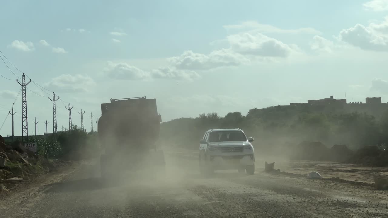 the road is driving through the fields at construction road