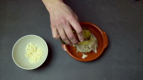 Chef-Finishing-Up-Risotto-With-Parmesan-Cheese-Flakes-And-Olive-Oil-On-Top